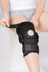 Knee Support Brace on leg isolated on white background. Elastic orthopedic orthosis. Anatomic...