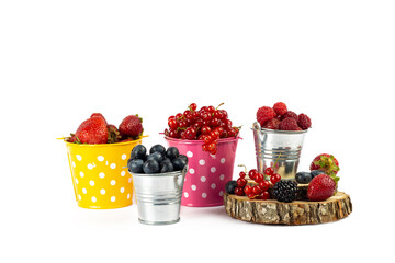 Berries mixed, blueberry, raspberry, red currant, strawberry, in metal bucket on white background.