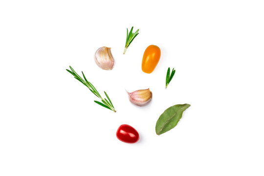 Various herbs and spices isolated on white background. Top view image rosemary, garlic, tomatoes and Laurel leaf with copy space.