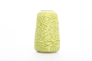 Yellow spool of thread isolated on white background. Skein of woolen threads. Yarn for knitting....