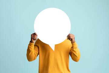Black man hiding behind empty communication chart