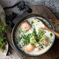 traditional finnish lohikeitto soup with salmon, potatoes, leeks and cream on the table