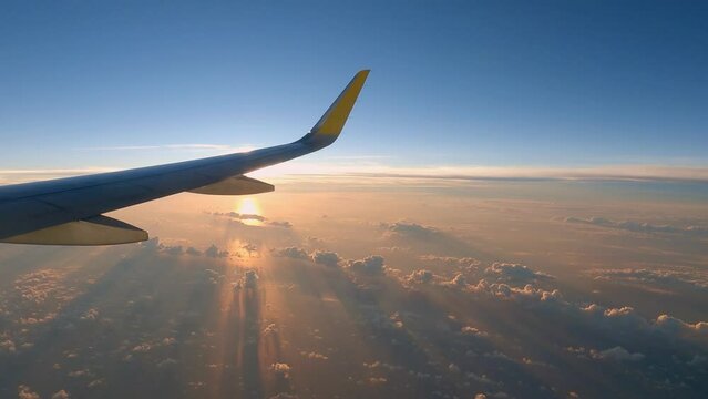 Airplane cloudy sunrise or sunset calm view right side of plane with sun covered by wing