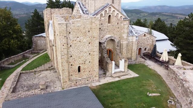 10 an old medieval stone monastery on top of a mountain hidden in a forest surrounded by large walls