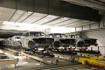 Car bodies are on assembly line. Modern automotive industry. Automobile conveyor. Interior of factory of manufacturing and production