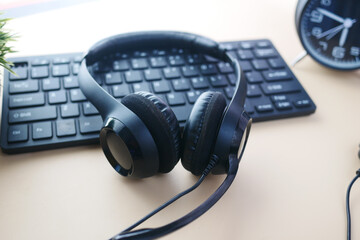 Obraz na płótnie Canvas call center headphone on laptop on table ,