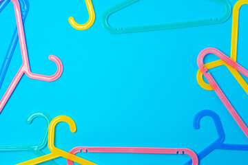 Blue hanger on trendy blue color background. Template fashion blog social media.