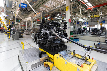 Photo of car bodies are on assembly line. Factory for production of cars. Modern automotive industry
