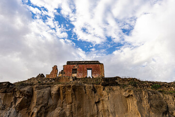 ruined castle in the canary islands in ruins with beautiful colors ruins of a bygone era of the canary islands with red colors known as the tojo de jinamar castle with ancient architecture