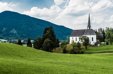 Fototapeta na wymiar Scenic view of a chapel and green hills over the German countryside in the village Kappel
