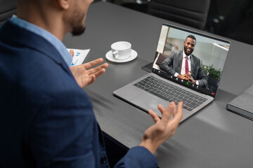 Cropped of businessman having video conference with black man