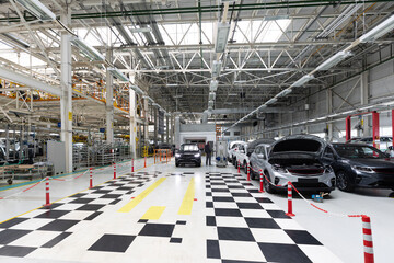 Modern car assembly plant. Auto industry. Interior of a high-tech factory, modern production of automobiles