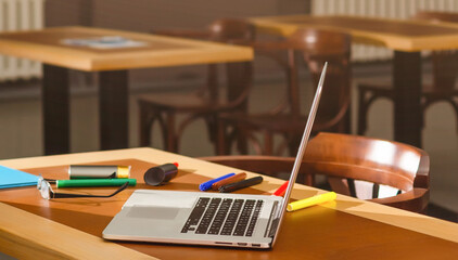 Working desk with laptop, notebook