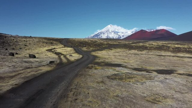 Road across big moss field in area of the Kamchatka volcano  Tolbachik, drone view