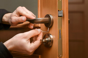 Door Handle Fixing. Repairman installs Door Knob by Screwdriver. Service Handle Door.