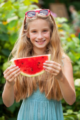 Portrait of a young little girl with watermelon