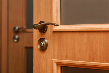 Obraz premium Door Handle on Wooden Door. Style New Door Knob at Home Interior
