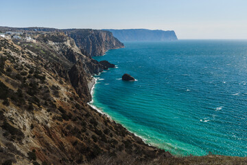 View of Crimean rugged rocky shore with Saint George Monastery and rock of Holy Apparition in spring. Sevastopol, Crimea