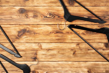 Composition with clothes hangers on wooden background.
