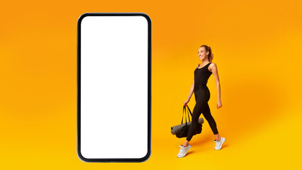 Fitness Woman Walking To Big Smartphone Blank Screen, Yellow Background