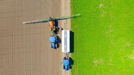 Aerial view on tractor with sprayer came for reload, herbicide and pesticide
