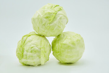 Fototapeta premium The raw cabbage product lies on a white background. Ingredients for cooking. Seasonal vegetables.