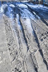 Fototapeta premium dirt rural road after rain. stakes from cars. rainy weather.