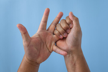 Office syndrome concept. Ring finger is massaged and stretched after working. Close up shot isolate...