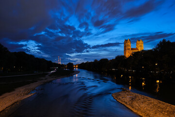 Munich view - Isar river, park and St Maximilian church from Reichenbach Bridge in twilight. Munchen, Bavaria, Germany.