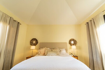a view of a bed and wall features inside a bedroom of a villa along the costa del sol  - obrazy, fototapety, plakaty