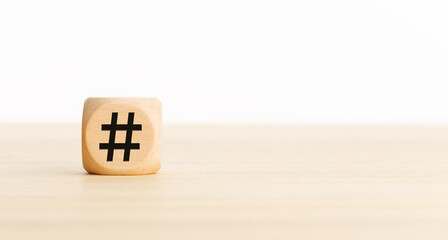 Hashtag symbol on wooden cube. Copy space