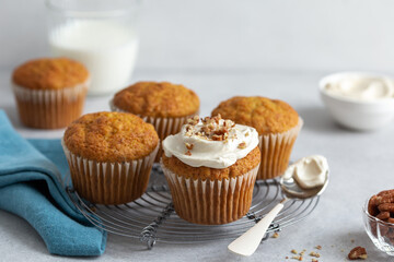 carrot and nuts muffins with cream cheese frosting