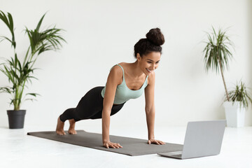 Remote Training. Sporty Lady Standing In Plank Position In Front Of Laptop
