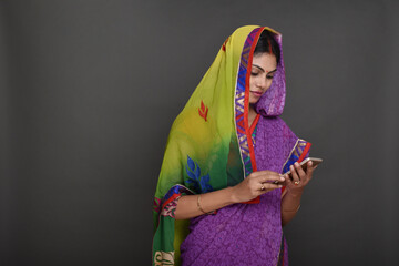 Portraits of young rural woman using smartphone