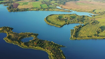 4K Blue Water Of Lake River And Green Countryside Landscape With Growing Greenery Forest. Aerial View Of Rivers Coast Islands.