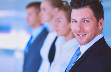 Smiling successful business team standing in office