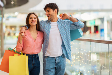 Happy Couple Hugging Doing Shopping Walking Together In Hypermarket