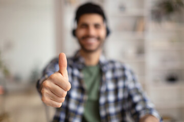 Portrait of smiling Arab man showing thumbs up