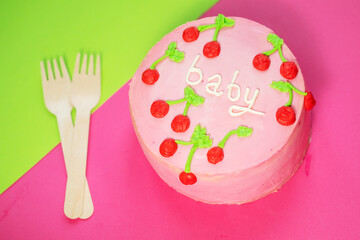 baby girl birthday cake on pink background