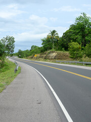 Fototapeta na wymiar Winding highway asfalt road in tropical country