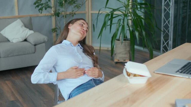 Young Woman Feels a Sharp Pain in the Upper Abdomen After a Quick Snack. Gastritis, Pancreatitis, Diabetes, Eating Disorder. Bad Food in Plastic Boxes, Office Food. Health and Bad Fast Food Concept.