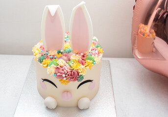 Trendy cake for children's Birthday party or Ester. Cheerful bunny with a muzzle and ears....