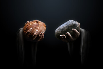 Hands of a man holding a stone and a bread. Religious biblical theme concept. - obrazy, fototapety, plakaty