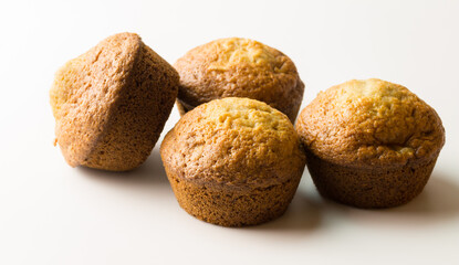 Small muffins isolated on white - little baked sweet cakes