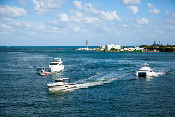 Bay and coast in clear, sunny weather, with yachts in motion in Fort Lauderdale, Florida, USA.