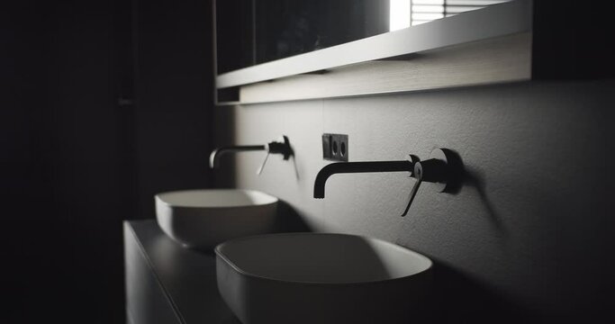 Real Contemporary minimalist bathroom with black and gray tone, with italian white furniture, elegance home, satisfaction and beautiful design forms, lifestyle. cozy bathroom. minimalistic faucet.