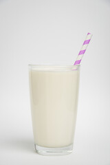 glass of milk with purple straw isolated on a white background