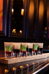 Variety of coffee and mint alcohol cocktail shots in a row