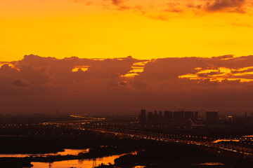 Freeway in night with cars light in modern city.