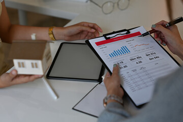 A portrait of a young pretty Asian doctor sitting in the office explaining the result to the patient for medical and health care concept.